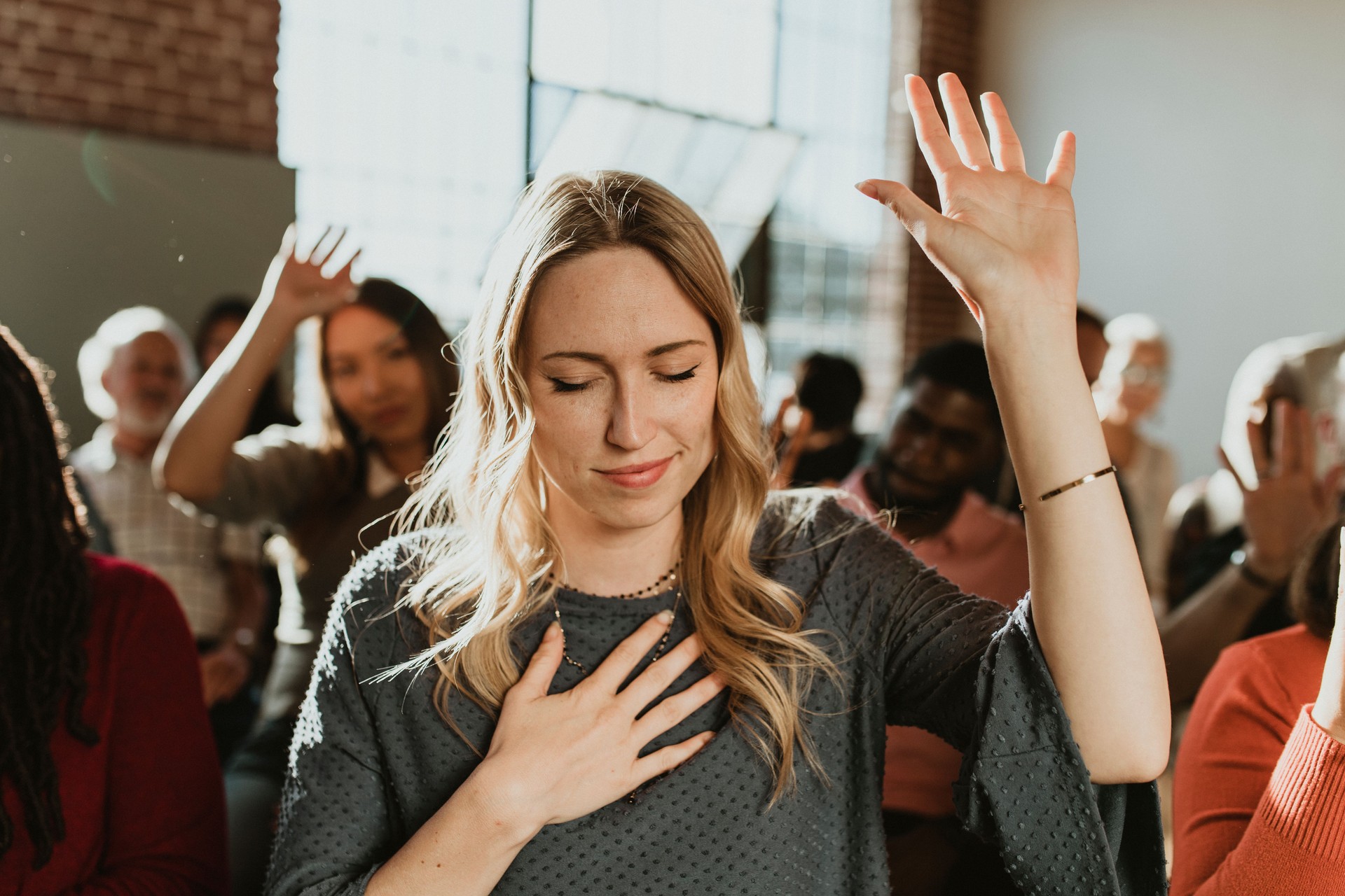 White woman raising her hand